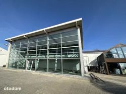 Commercial glass building with large windows.