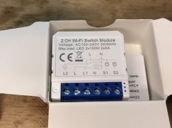 AVATTO Dual Relay Wi-Fi Switch Module View of AVATTO dual relay Wi-Fi switch module in an open box.