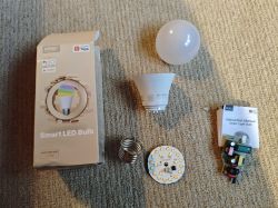 Parts of Moes Smart LED Bulb with packaging and manual.