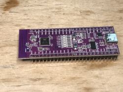 W801 microcontroller board placed on a wooden table.