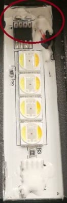 White glue covering a connector section on an LED board.