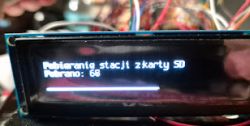 Display showing a message about downloading stations from an SD card with a progress bar.