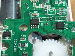 Close-up of Circuit Board with Electronic Components Circuit board with electronic components and gears.