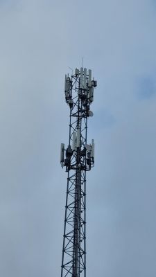 Wieża z antenami telekomunikacyjnymi na tle nieba.