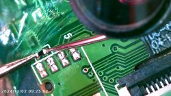 Close-up of a printed circuit board (PCB) with visible solder joints and electronic components.