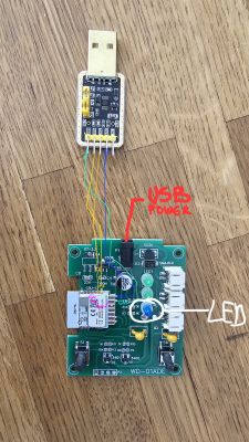 The image shows a circuit board connected to a USB adapter using colored wires.