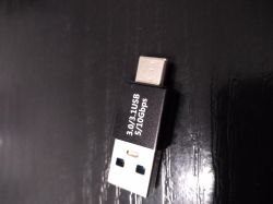 USB-A to USB-C adapter labeled 3.0/3.1 5/10 Gbps on a black surface