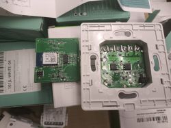 Two electronic modules with visible circuit components and QR codes on a table.