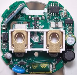 Close-up of the interior of an electronic USB plug showing components.