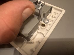 Close-up of ground lug inside an electrical socket mounted in plastic housing