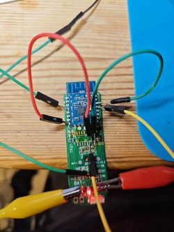 Electronic circuit prototype with wires and LED on a PCB.