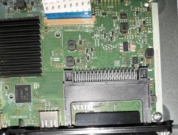 Close-up of a PCB with a ribbon connector socket, a heatsink, and the printed text “VESTEL”