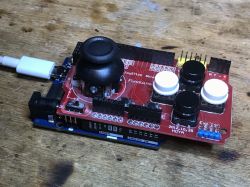 Joystick Shield on Arduino R4 WiFi Joystick shield mounted on an Arduino board with a connected USB cable.