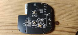 Printed circuit board with buttons and electronic components.
