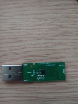 Close-up of a printed circuit board inside an opened USB flash drive.
