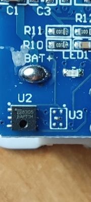 Close-up of a circuit board with visible electronic components and markings.