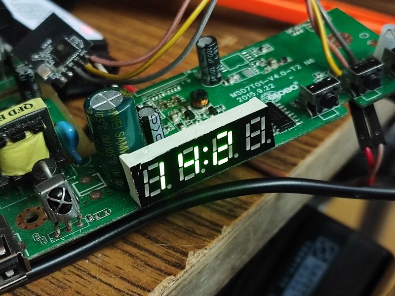 LED Display on PCB with Wiring Close-up of a green PCB with an LED display showing 8:8.8 and connected wires.