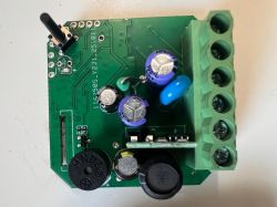 Circuit board with capacitors, screw terminal, and black antenna