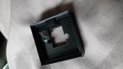 Black plastic casing on a gray background with a rectangular hole in the center.