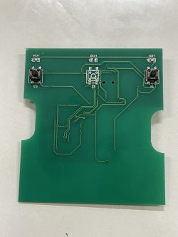 Green printed circuit board with several buttons and traces.