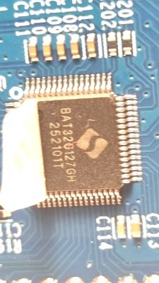 Close-up of BAT32G12 IC on a blue PCB with SMD components
