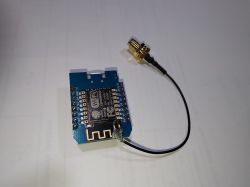 ESP8266 module with a soldered antenna cable and SMA connector.