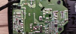 Charger Circuit Board with Electronic Components Close-up of a charger circuit board with visible electronic components and traces.