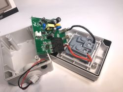 Inside of a disassembled electrical socket with visible PCB and wiring.