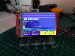 TFT screen on a circuit board shows “eM Katowice,” VU meters, MP3 settings, and time 11:47:27