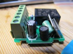 PCB module of a smart switch with a relay and capacitors.
