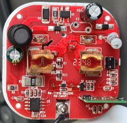 Close-up of a red circuit board interior with various electronic components.