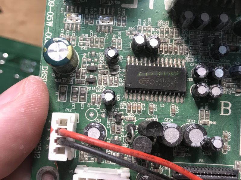 Close-up of PCB with PT7314E chip and connector with red and black wires