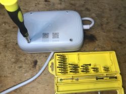 Disassembly of LDNIO SEW3452 Power Strip Screwdriver opening power strip case with a set of bits.