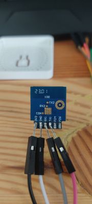 Electronic module with connected wires on a wooden table.