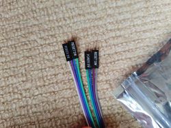 RESET and POWER Switch Cables A set of cables for RESET SW and POWER SW switches on a beige carpet, next to an antistatic bag.