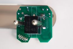 Smart Plug Components with Integrated Circuit Close-up of the internal components of a smart plug with a visible integrated circuit.