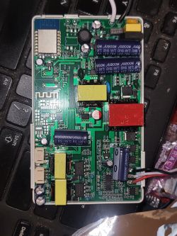 PCB of Smart Ceiling Fan Circuit board with electronic components on a black keyboard background.