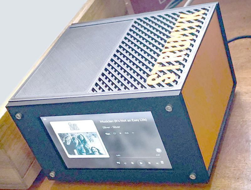 Modern audio device with display screen and STRUNYK lettering on top panel