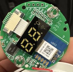 Close-up of an electronic board with an LED display and WBR2 chip.