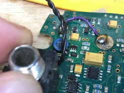 Close-up of a metal detector PCB with electronic components and a detached socket.