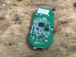 Sonoff DW2-WiFi Sensor PCB Sonoff DW2-WiFi door sensor PCB on a wooden background