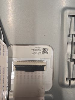 Zbliżenie złącza taśmy i etykiety z kodem QR na module TV Samsung