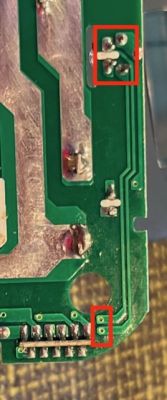 Circuit Board with Markings Image of a circuit board with red-marked areas on the traces.