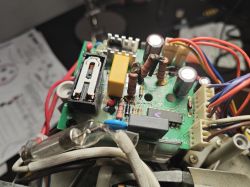 Power PCB with components, showing charred resistors and wiring inside a device housing