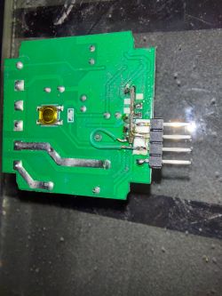 Photo of a green circuit board with visible pins and wires.