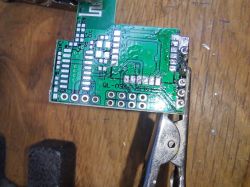 Desoldered LMA35 circuit board held by a clamp.