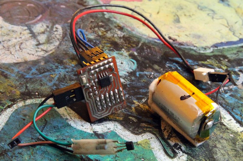 DIY board with ATTiny13 microcontroller and Li-Po battery on a work surface