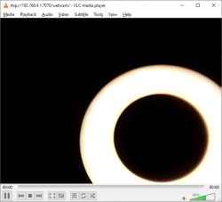 Glowing light ring partially visible in webcam stream Bright circular light ring on black background, partial view of the ring.