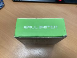 A green box with the text WALL SWITCH on a desk.