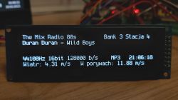 LCD display showing information about a radio station and wind conditions.